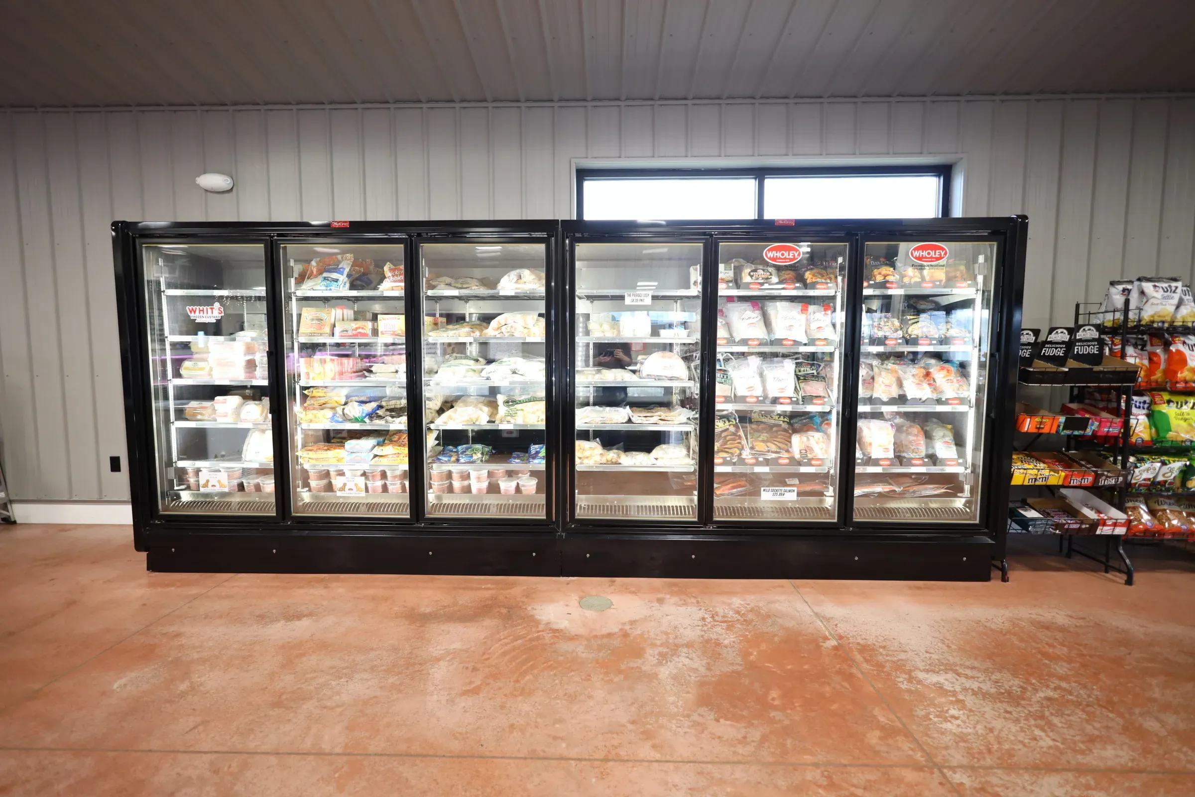 commercial refrigeration units lined up with food inside